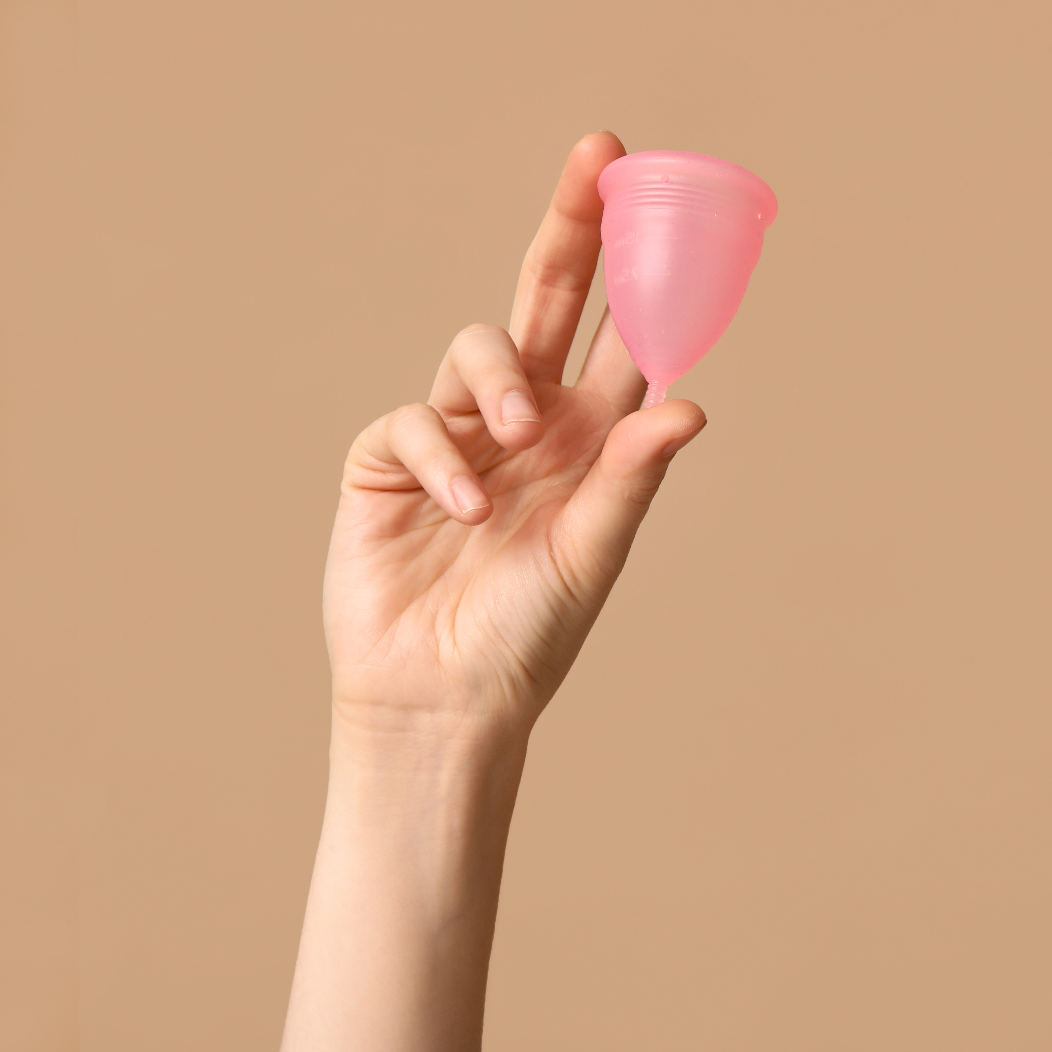 Hand holding menstrual cup